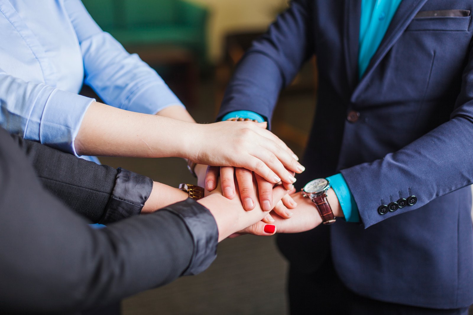 people standing office holding hands together